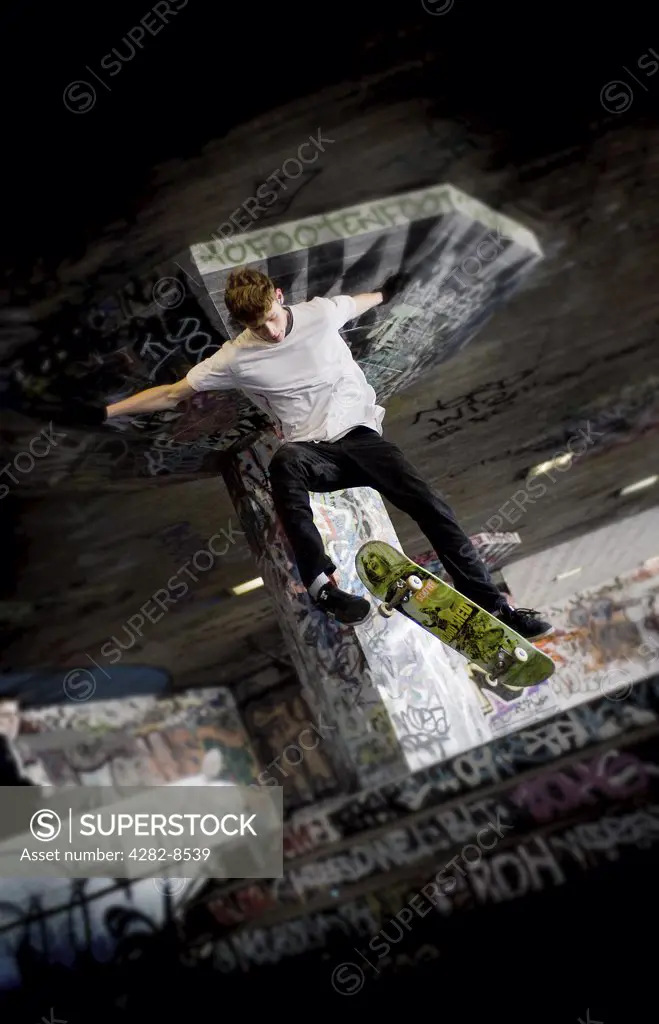 England, London, South Bank. A skateboarder performing a stunt at the undercroft on the South Bank.