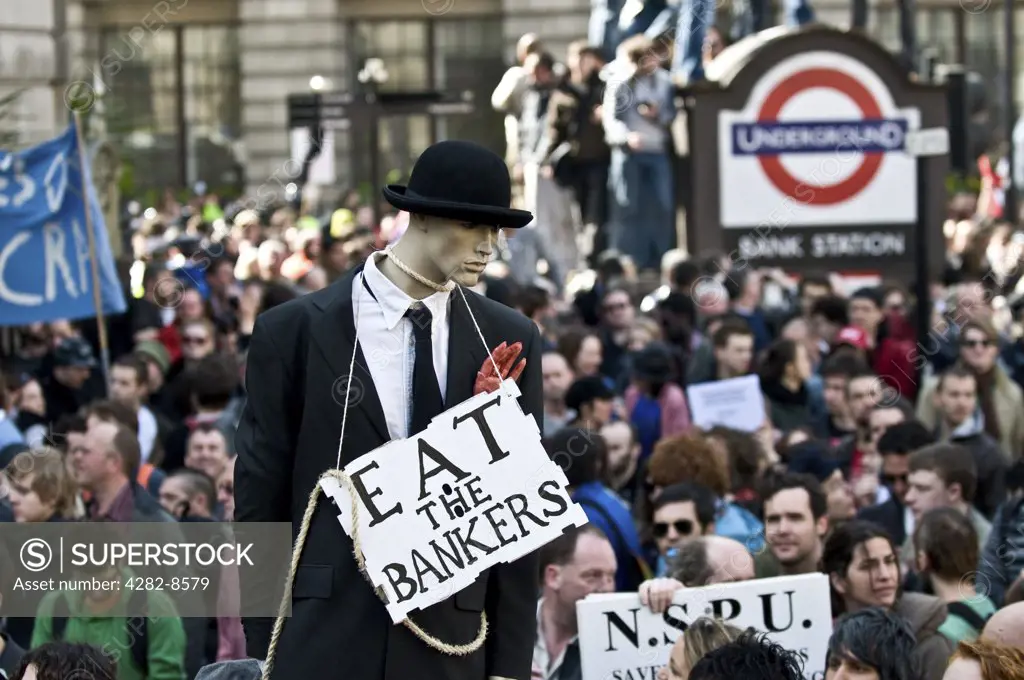 England, London, City of London. A sign saying 'Eat the Bankers' around the neck of a mannequin dressed in a suit at the G20 demonstration in the City of London.