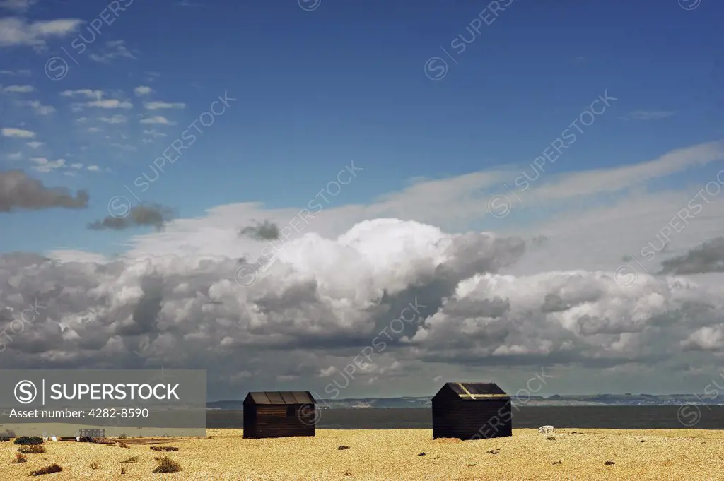 England, Kent, Dungeness. Wooden huts on the shingle beach at Dungeness.