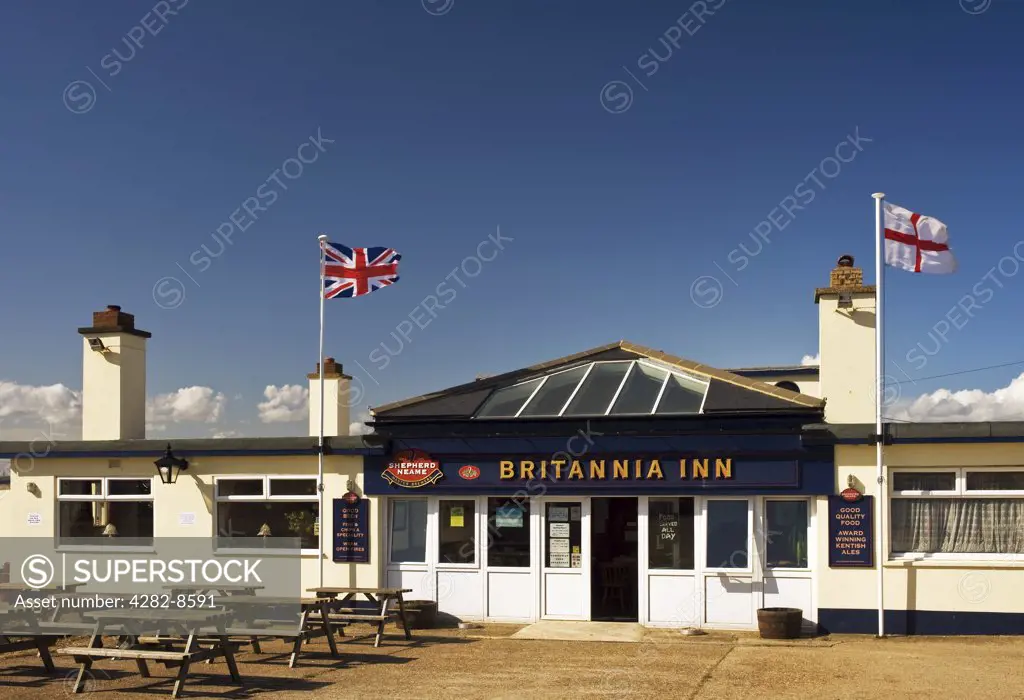 England, Kent, Dungeness. A Union and English flag flying outside The Britannia Inn public house in Dungeness.