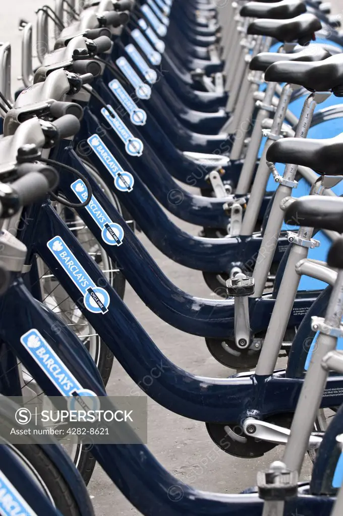 England, London. A row of Barclays Cycle Hire scheme bikes in a docking station.