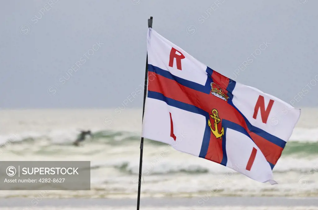 England, Cornwall, Gwithian Towans. A RNLI flag on Gwithian Towans beach.
