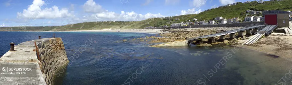 England, Cornwall, Sennen Cove. A panoramic view of Sennen Cove featuring the Sennen Cove Lifeboat Station.