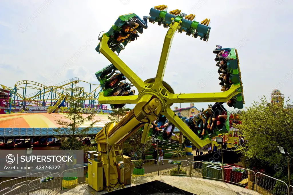 England, Essex, Southend-on-Sea. Dragon's Claw, a ride that spins people upside down at Adventure Island in Southend-on-Sea.