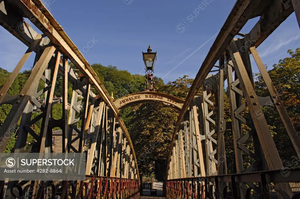 England, Derbyshire, Matlock Bath. The Jubilee Bridge built in 1887 over the River Derwent in Matlock Bath. The iron bridge was constructed for the Golden Jubilee of Queen Victoria.