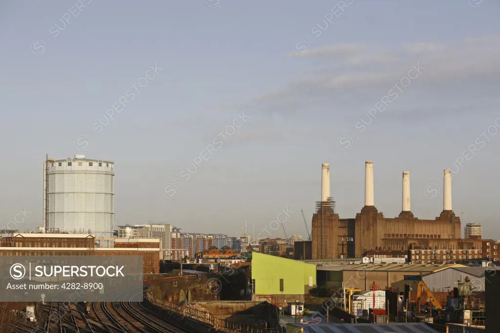 England, London, Battersea. Railway tracks leading past the iconic London landmark, Battersea Power Station, which ceased producing electricity in 1983.