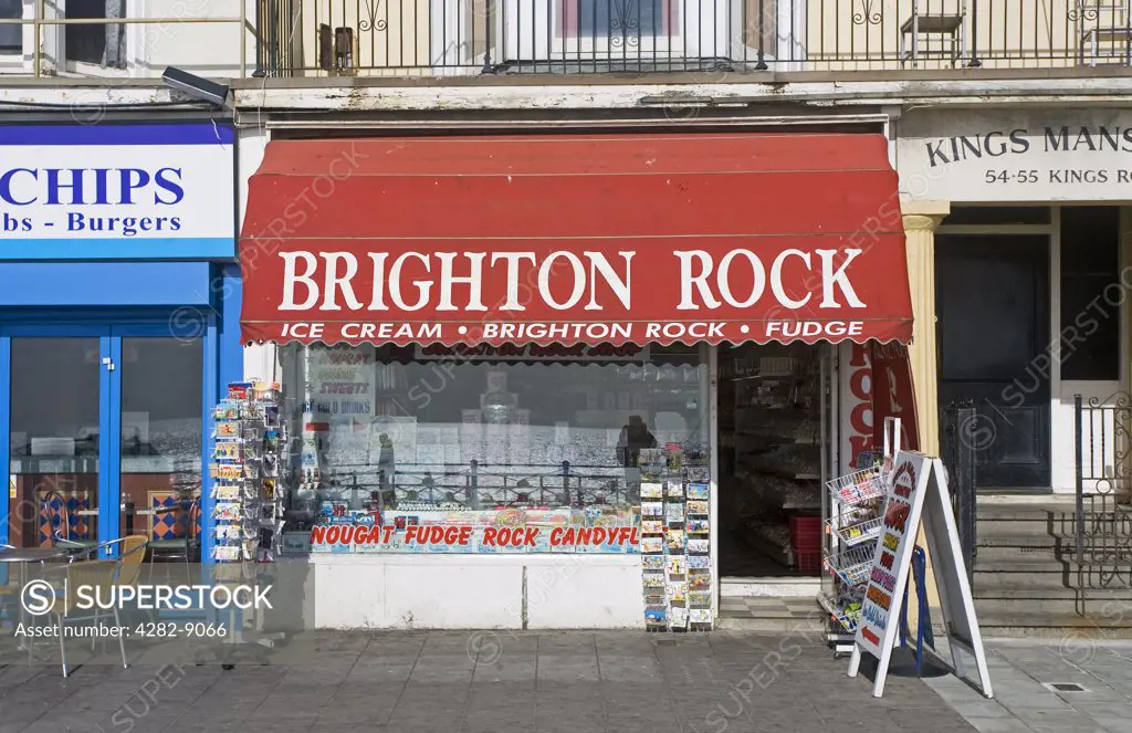 England, City of Brighton and Hove, Brighton. Brighton Rock shop selling postcards, ice cream, Brighton rock and fudge on the seafront in Brighton.