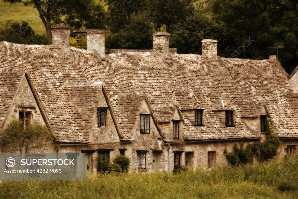 England, Gloucestershire, Bibury. Arlington Row, originally built in 1380 as a monastic wool store, they were converted in the 17th century into a row of weavers' cottages.
