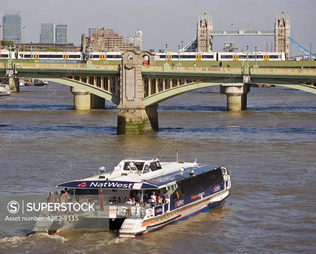 England, London, Southwark Bridge. A Thames Clipper boat heading east towards the City of London, Southwark Bridge and Tower Bridge.