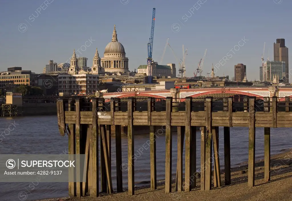 England, London, Blackfriars Bridge. A jetty on the South Bank of the River Thames with Blackfriars road bridge and St. Paul's Cathedral in the background.