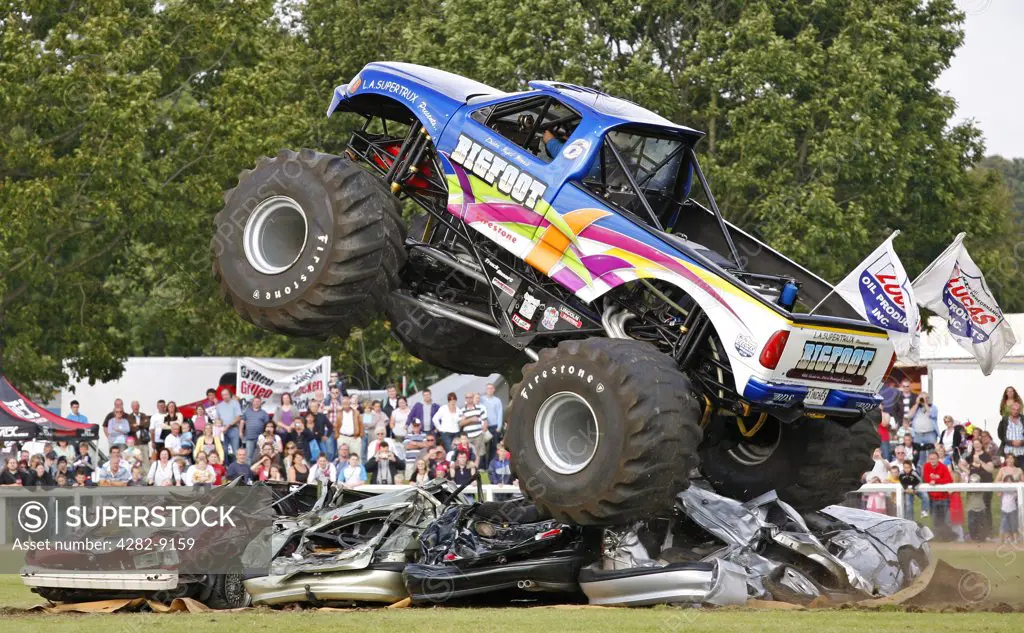 England, Warwickshire, Coventry. The world's no. 1 Monster Truck 'Bigfoot' performing in a car crushing challenge at the Stoneleigh Park Country Festival 2009.