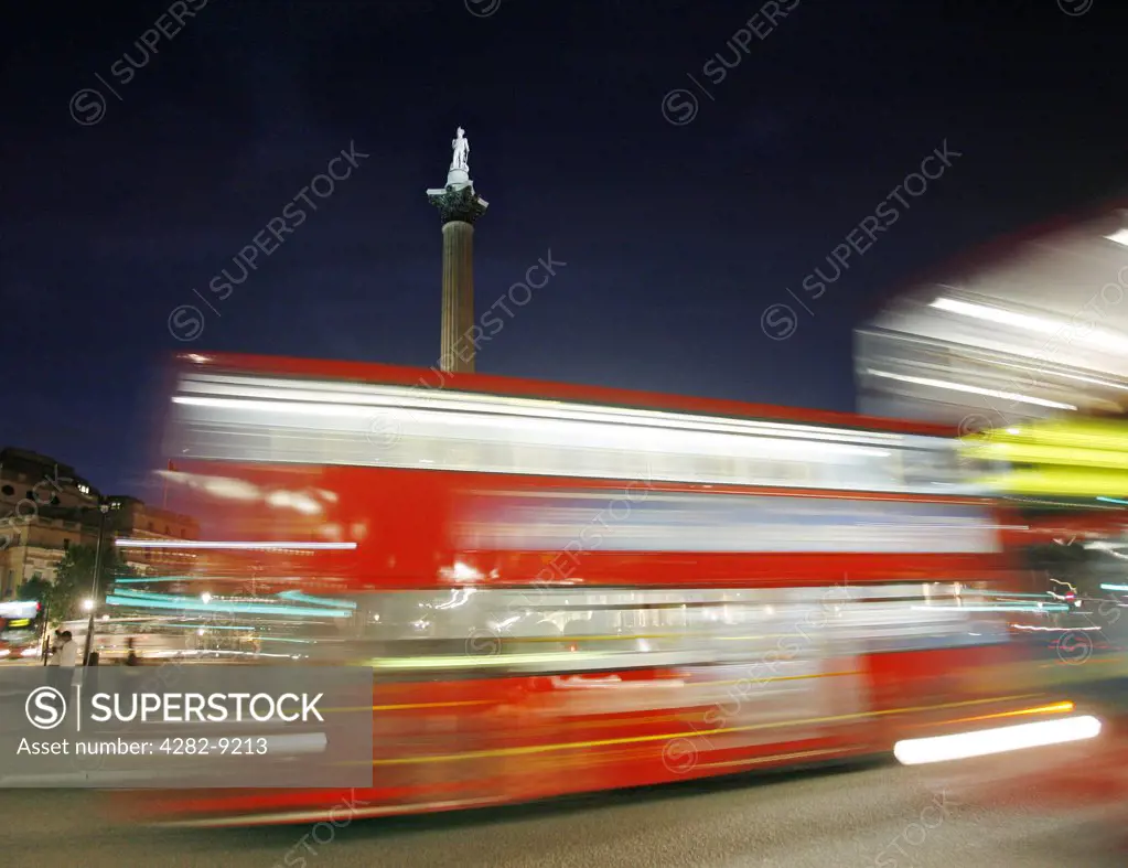 England, London, Trafalgar Square. Trafalgar Square at night as a red bus goes past in Central London.