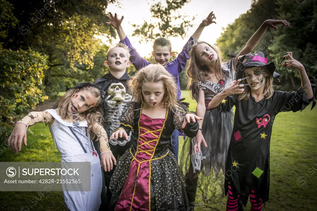 Children pose in zombie costumes for Halloween Night.
