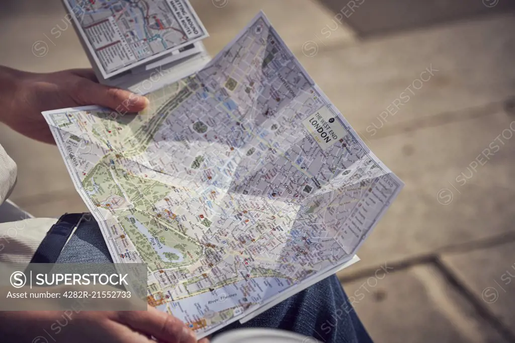 A tourist holds a map of London.