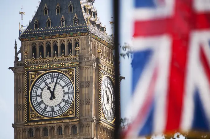 England, London, Westminster. Union Flag hanging on the Royal Wedding route in London's Parliament Square with the iconic clockface of Big Ben in the background.