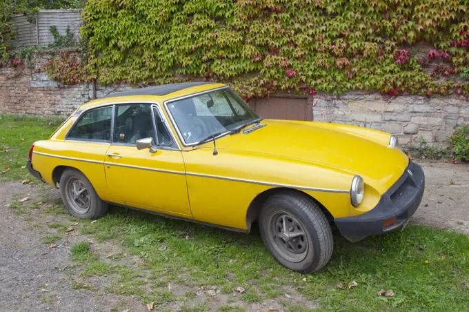 England, Somerset, Taunton. A yellow MGB, an iconic British sports car first built in 1962. Production finished in 1980.