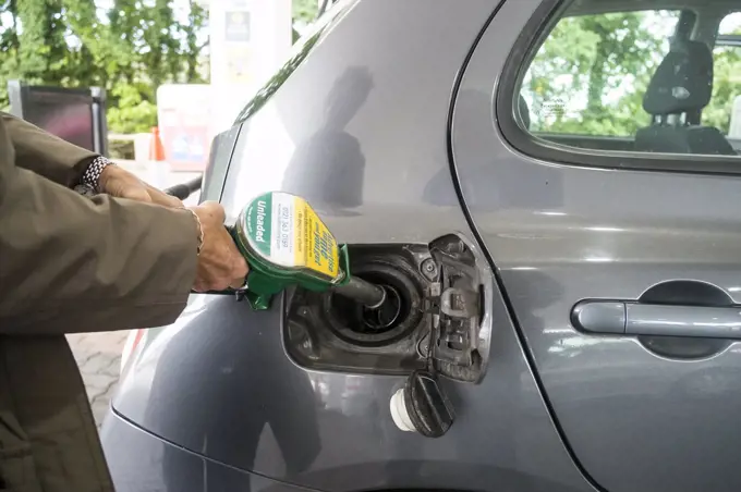 A customer filling a car with unleaded petrol.