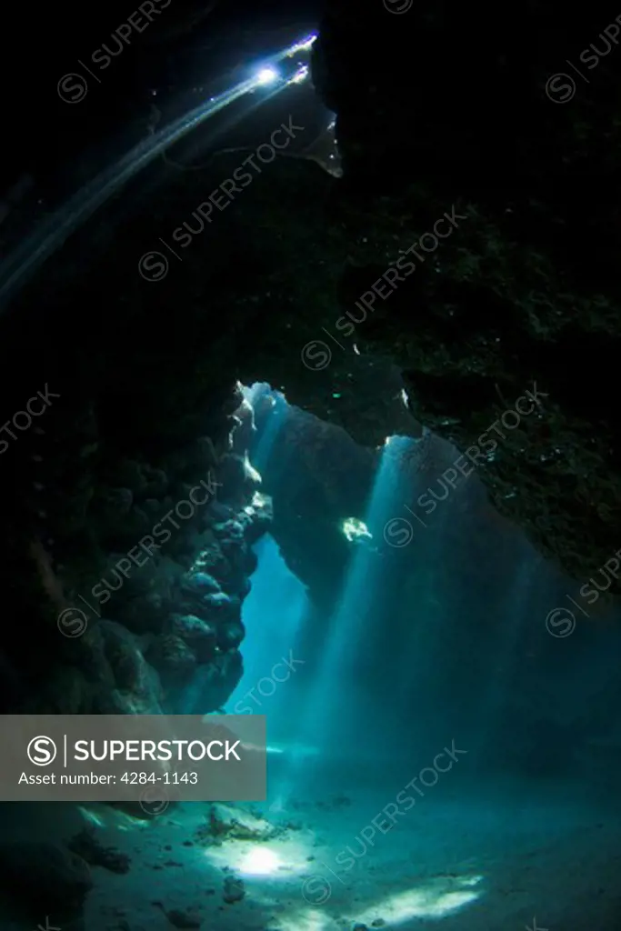 Sunbeam passing through underwater caves with coral, Red Sea, Egypt
