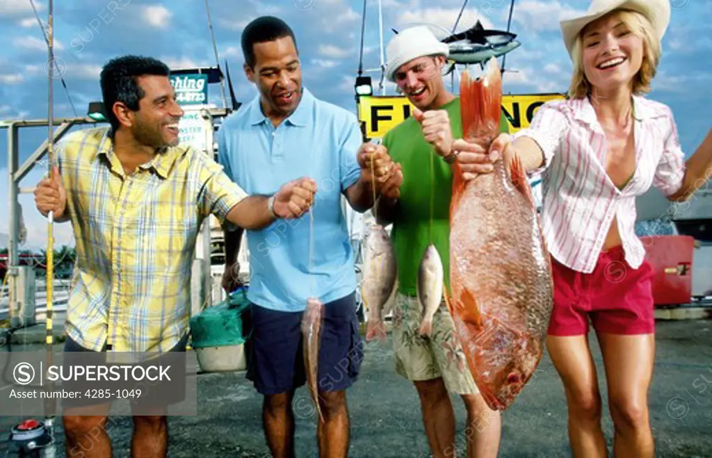 Woman shows up the men in deep sea fishing.