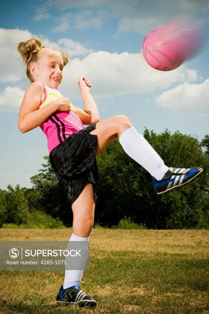Girl playing soccer.