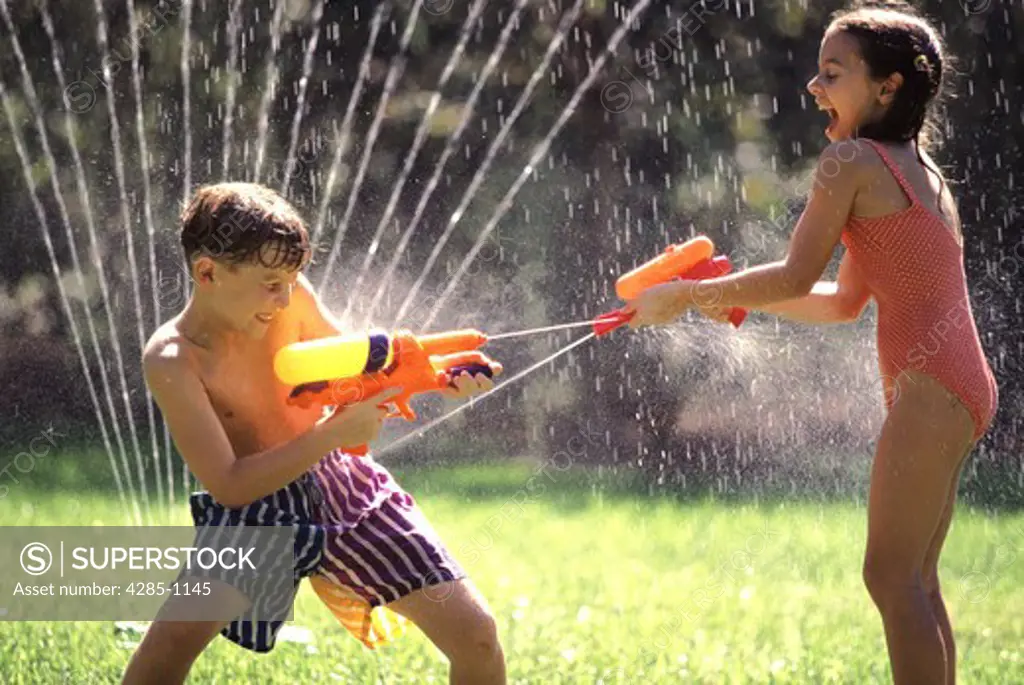 Kids playing with squirt guns on a summer day.