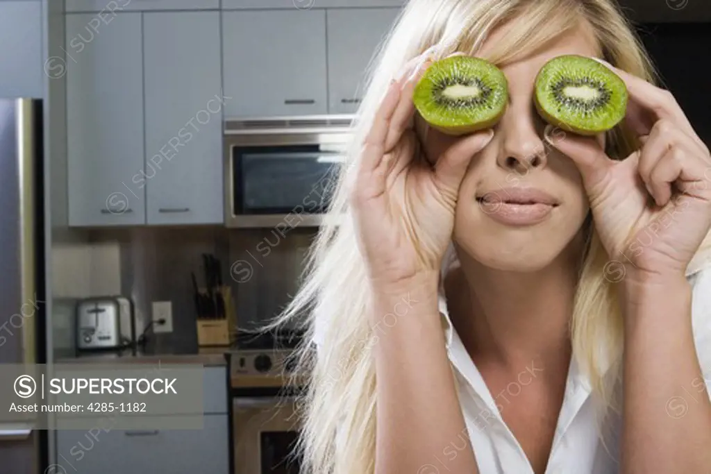 Young woman acting goofy while preparing a meal