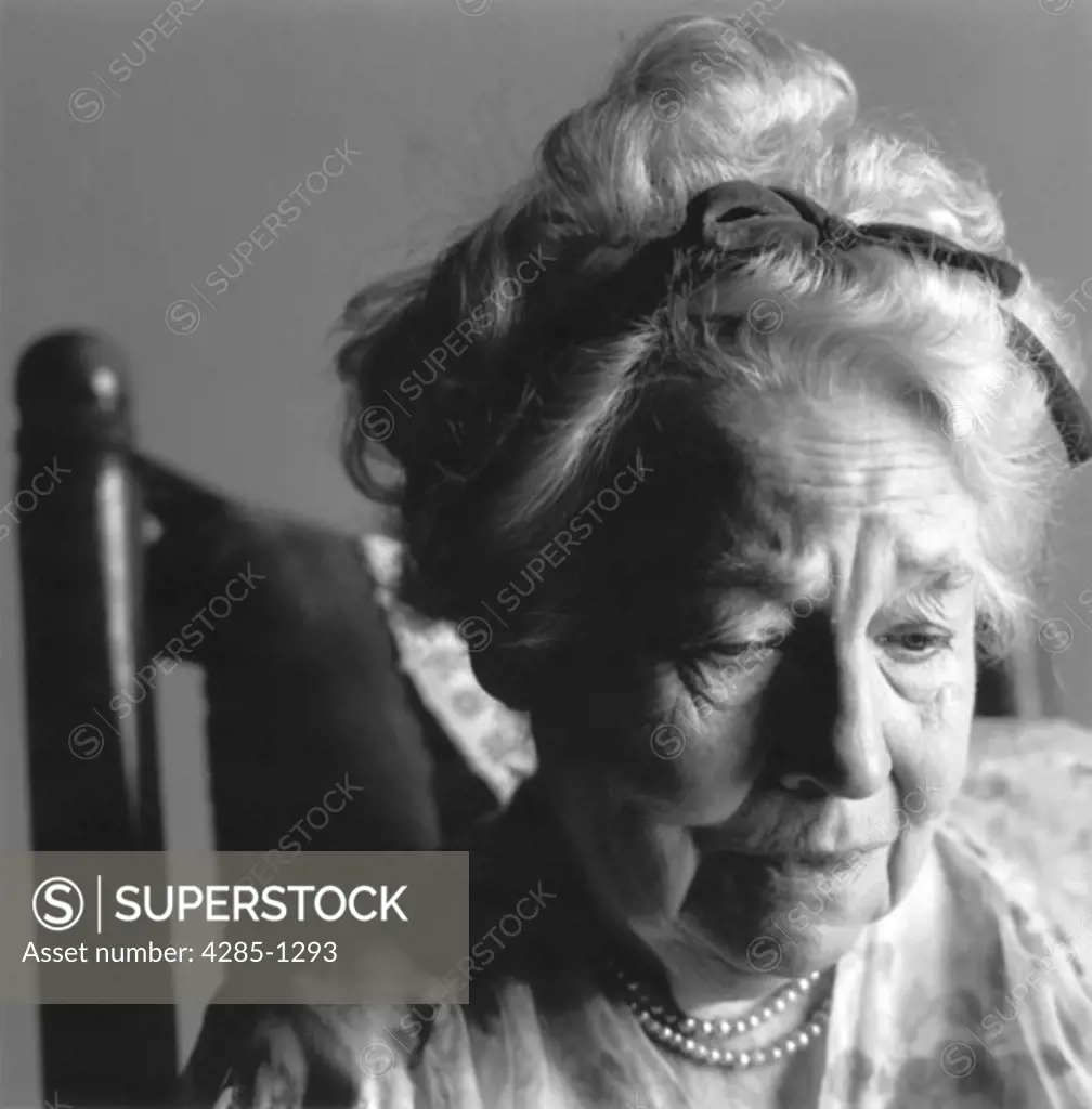Portrait of an elderly woman looking thoughful.