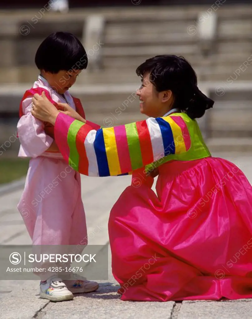 Mother and child in traditional costumes in Piwon Secret Gardens, Seoul, South Korea