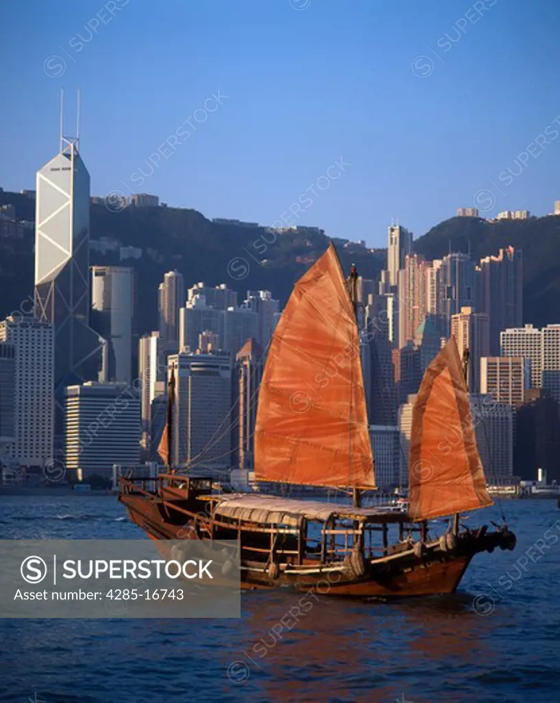Chinese Junk and skyline of Central District and Victoria Harbor in Special Administration Region, Hong Kong, China