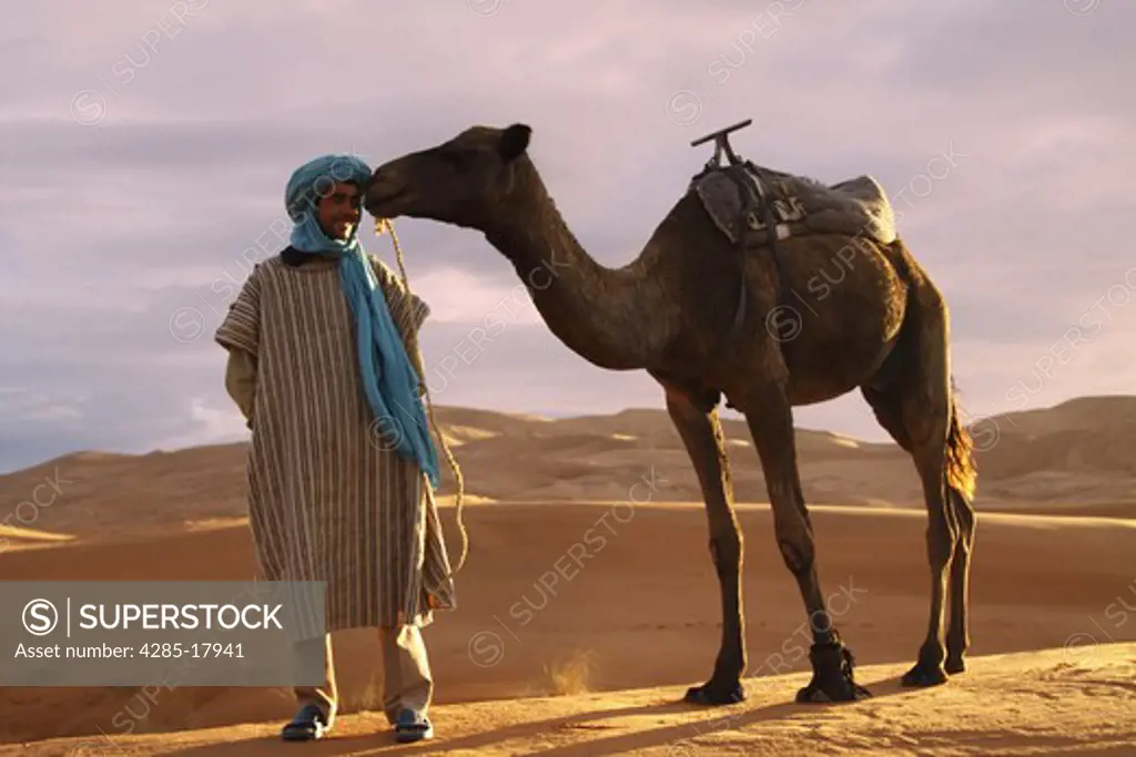 Africa, North Africa, Morocco, Sahara Desert, Merzouga, Erg Chebbi, Berber Tribesman with Camel
