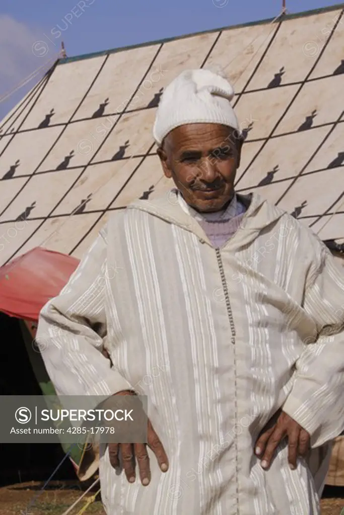Africa, North Africa, Morocco, Meknes, Berber Man Outside Decorated Tent
