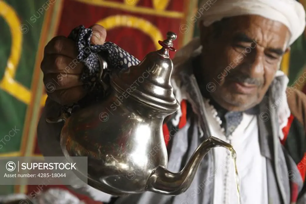 Africa, North Africa, Morocco, Meknes, Decorated Berber Tent, Man Pouring Tea