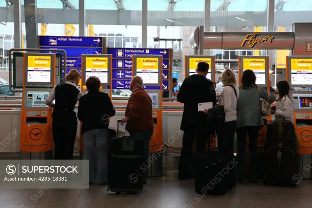 Germany, Frankfurt, Frankfurt International Airport, Terminal 1, Travellers at Boarding Pass Vending Machines