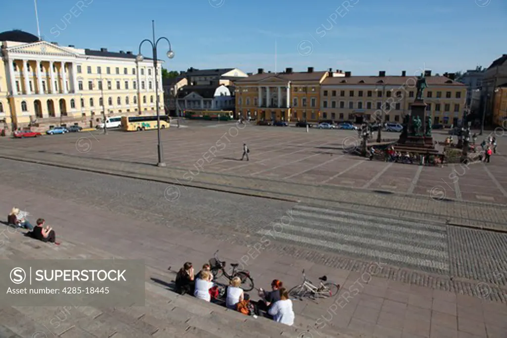 Finland, Helsinki, Helsingfors, Senate Square, Tourists Sitting on the Steps of The Cathedral