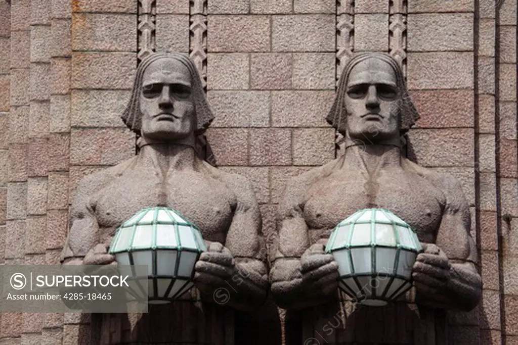 Finland, Helsinki, Helsingfors, Central Railway Station, Rautatientori Metro Station, Entrance, Stone Statues Holding Spherical Lamps