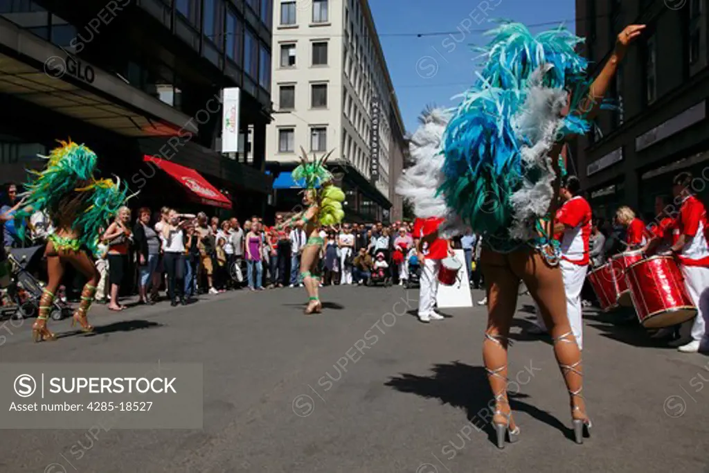 Finland, Helsinki, Helsingfors, Street Dancers, Women Performers Wearing Colourful Costumes, Rear View