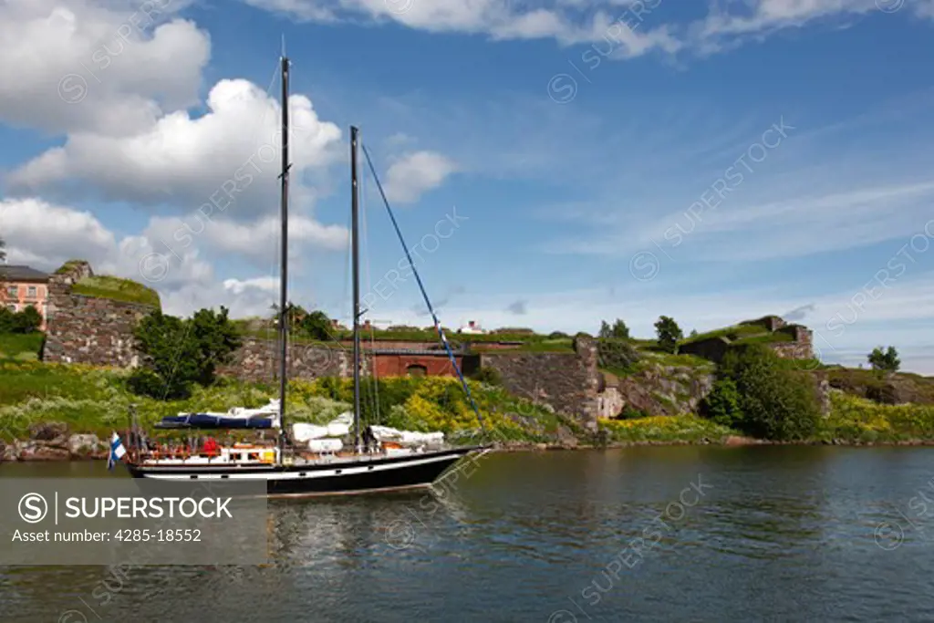 Finland, Helsinki, Helsingfors, Suomenlinna Island, Harbour, Yacht, Historic Buildings and Fortress Walls in the Background