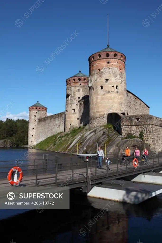 Finland, Region of Southern Savonia, Saimaa Lake District, Savonlinna, Kyronsalmi Straits, Olavinlinna Medieval Castle, St. Olaf's Castle, Tourists on Bridge
