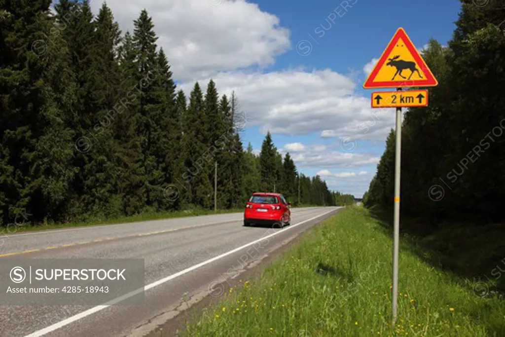 Finland, Region of Southern Savonia, Savonlinna, Punkaharju Ridge, Highway Number 14, Road Sign For Elk, Red Automobile