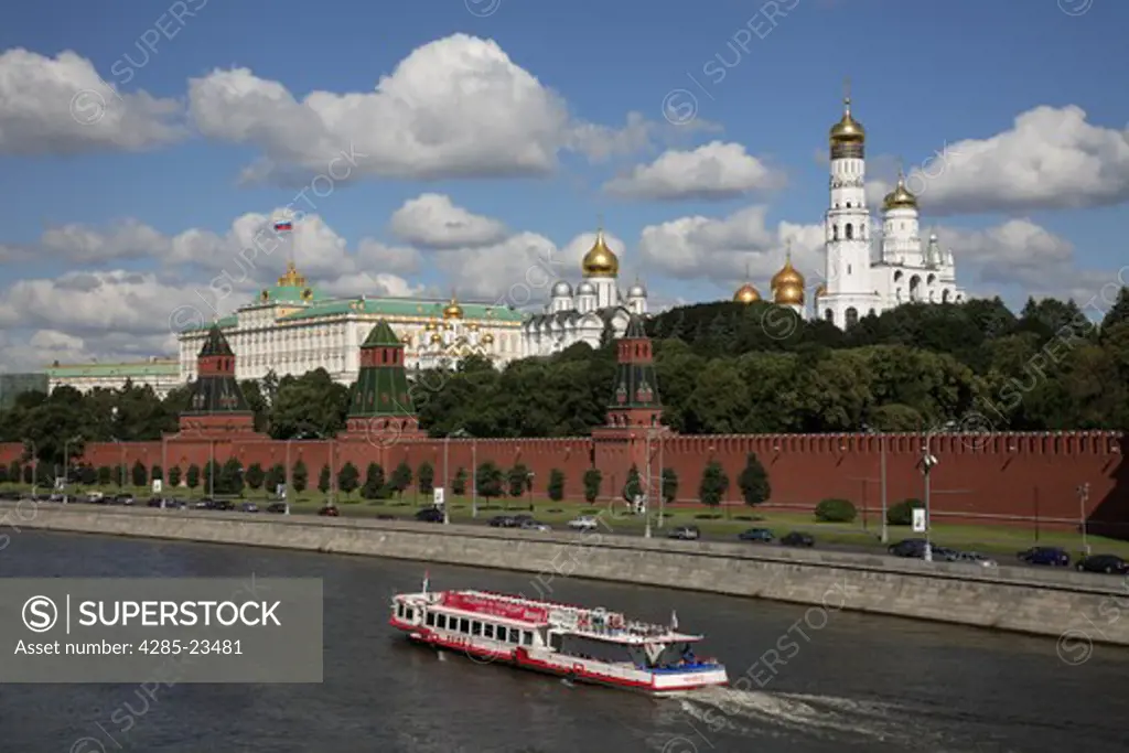 Russia, Moscow, The Kremlin, Moscow River, Tourist Boat. (Flag digitally added over Kremlin.)