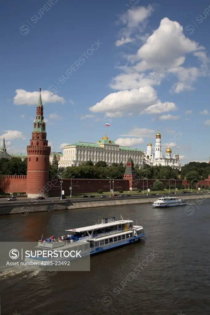 Russia, Moscow, The Kremlin, Moscow River, Tourist Boats. (Flag digitally added over Kremlin.)