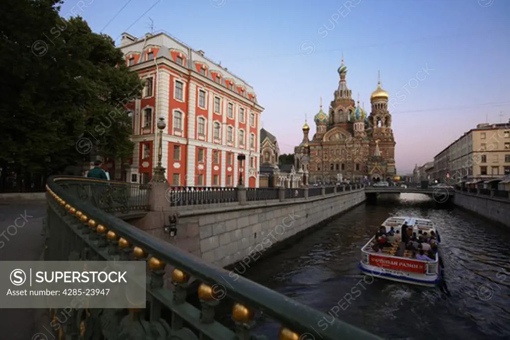 Russia, St Petersburg, Church of the Resurrection (Church on Spilled Blood), Griboedov Canal, Theatre Bridge, Tourist Boat. Sunset