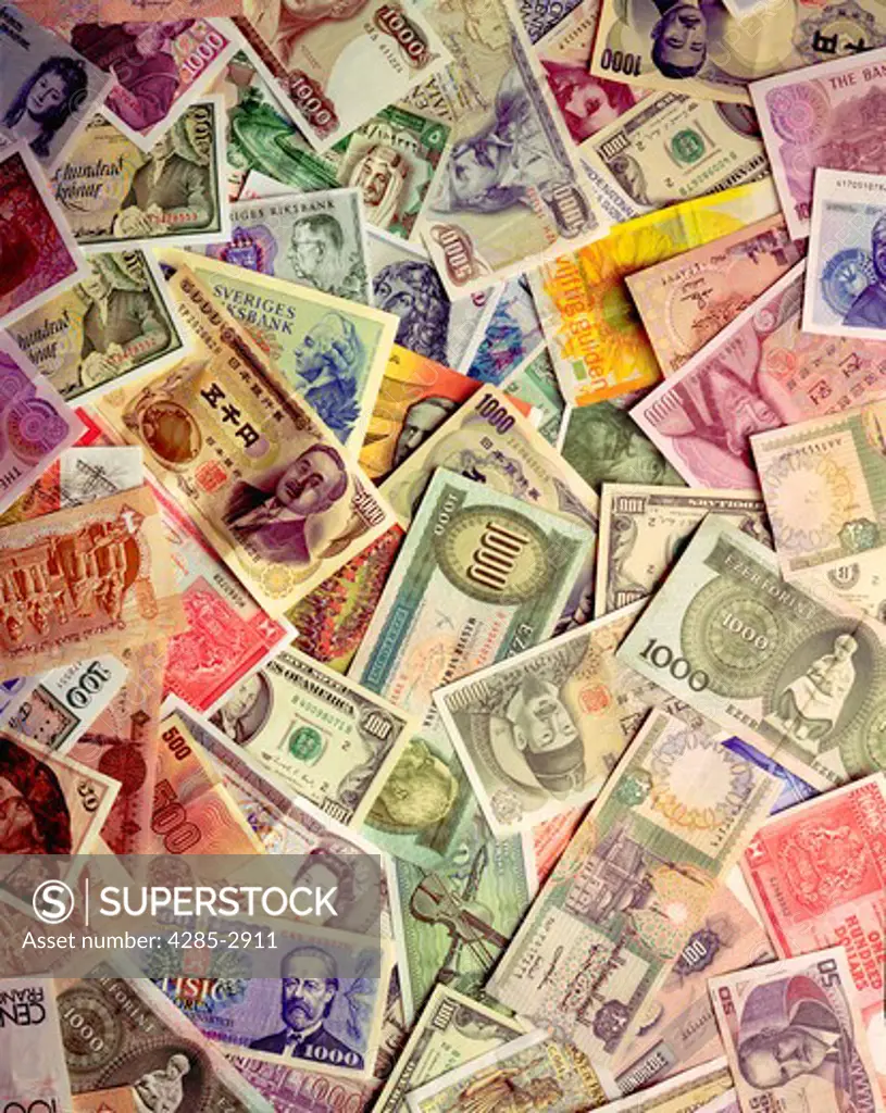 Colorful montage of various forms of international currency .