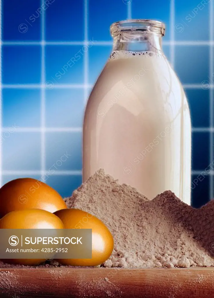 Still life of a pile of flour, three eggs and a glass container of milk.