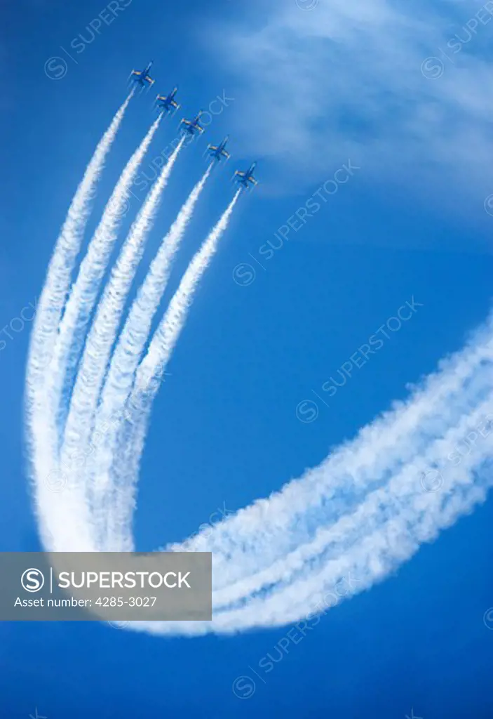 The U.S. Navy Blue Angels doing a synchronized maneuver.