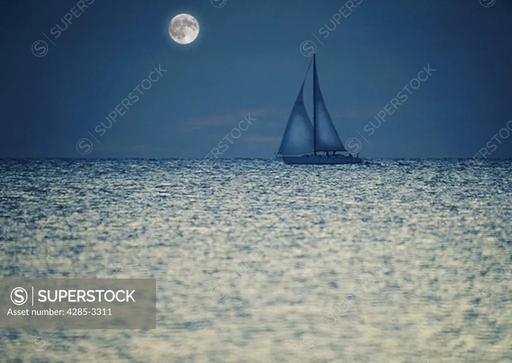 Two masted sailboat semi-silhouetted in shiny ocean at night with moon in background.