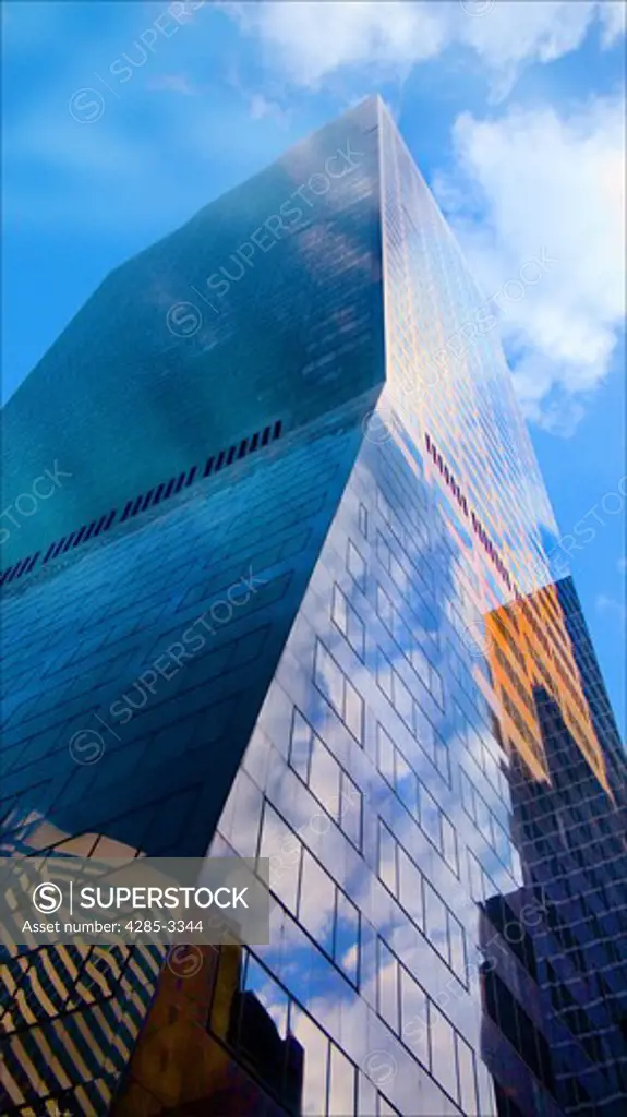 Large modern skyscraper building in Manhattan, New York, dramatic angle looking up.