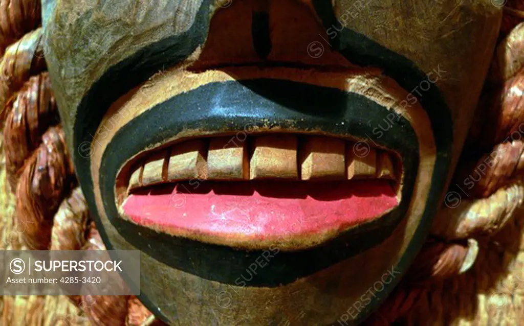Native American wood carving closeup showing teeth, lips and part of face.