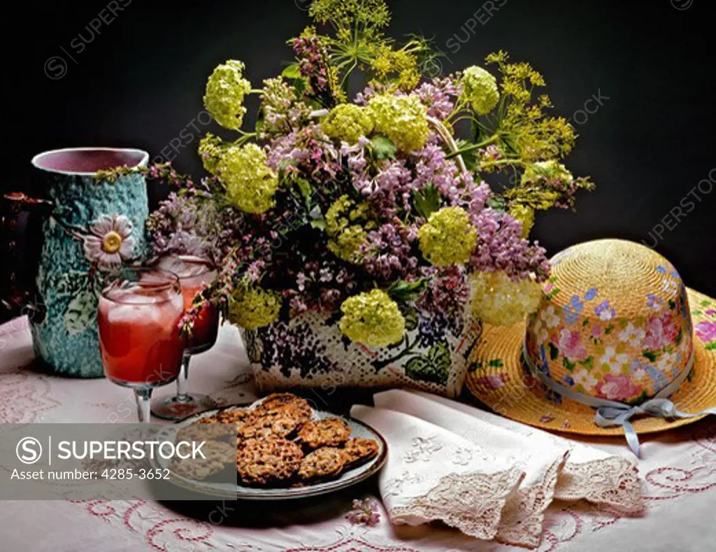 STILL LIFE OF FLOWERS, COOKIES AND HAT