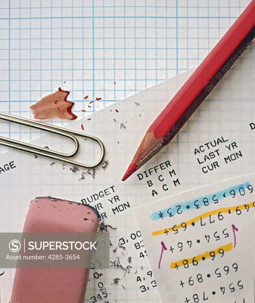 CLOSEUP OF LINED PAPER, PENCIL, ERASER, PAPER CLIP AND ACCOUNTING NUMBERS